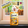 Image of a cat licking window for DREAMIES ShakeUps Rockin Roost 55g - Pets Villa. 