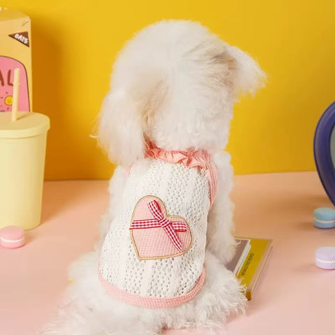 Image of a dog wearing the pink ariant of Heart Bow Summer Pet Sweater - Pets Villa. 